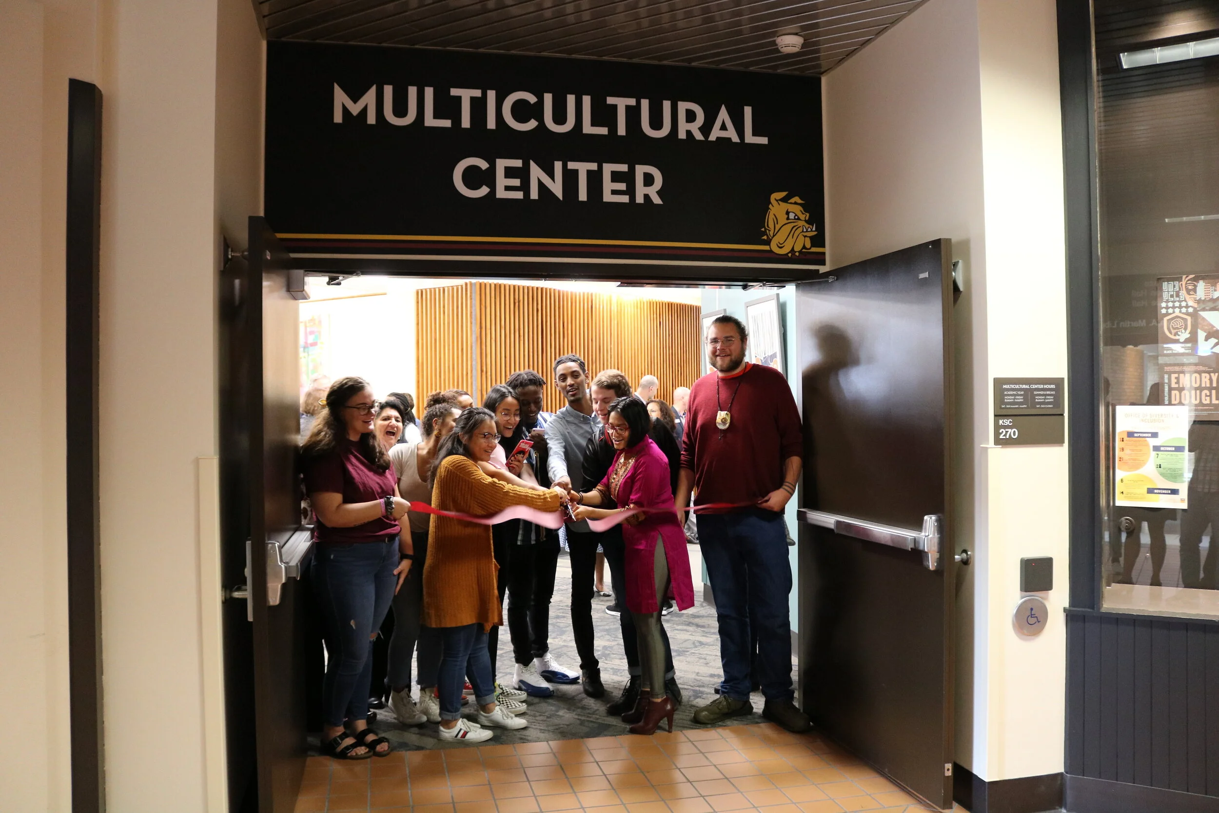 Students and faculty officially reopen the Multicultural Center with a ribbon cutting ceremony at the spaces main entrance. Photo courtesy Kirby Student Center