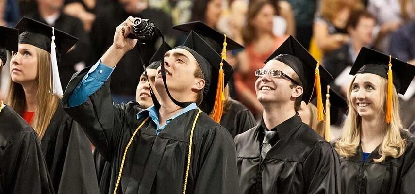 A student takes a photo of the video board during commencement in 2012. Photo courtesy of the University of Minnesota Duluth web archive