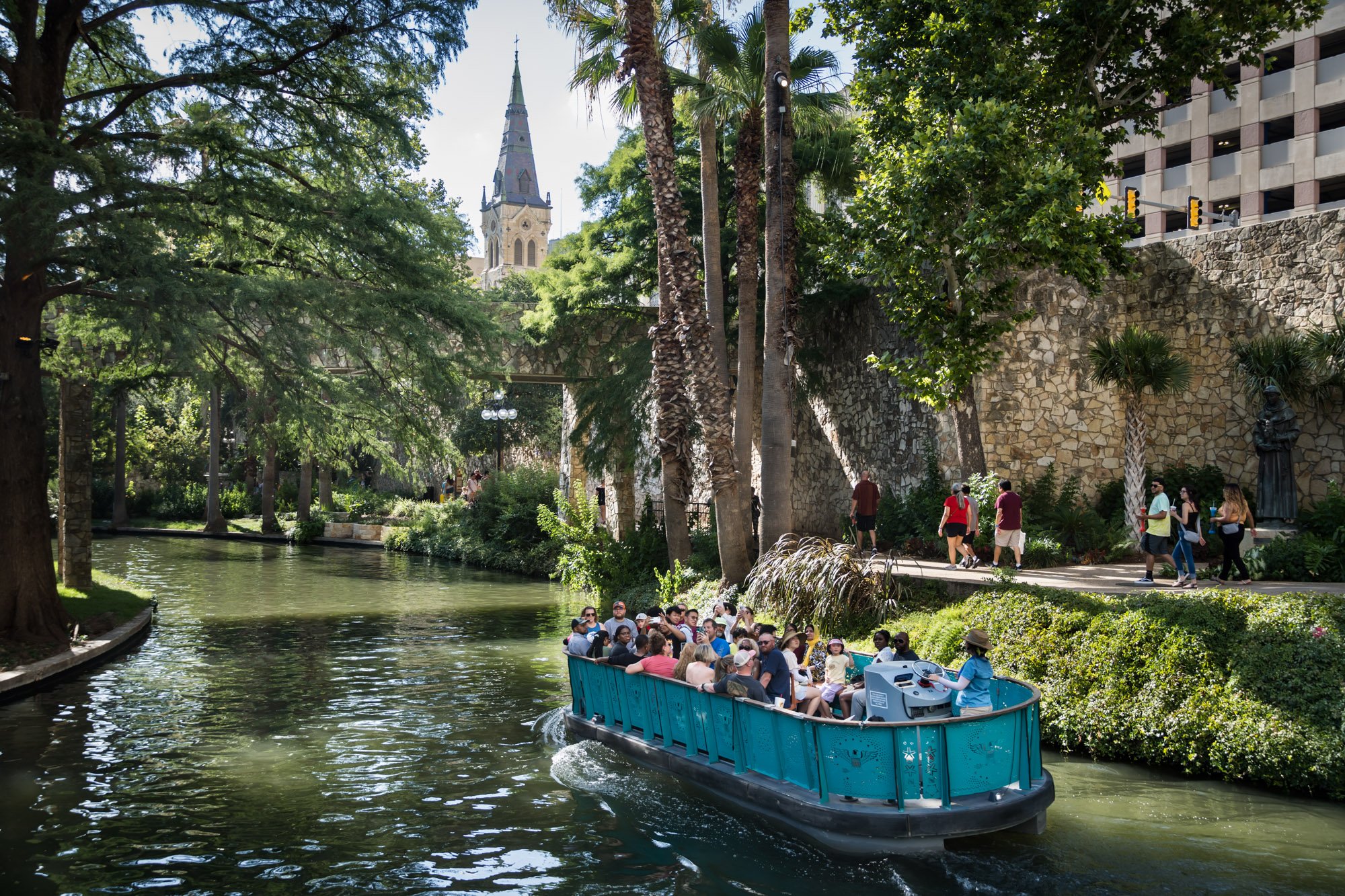 Tourists traveling by ferry on the Riverwalk by San Antonio travel photographer, Kelly Williams