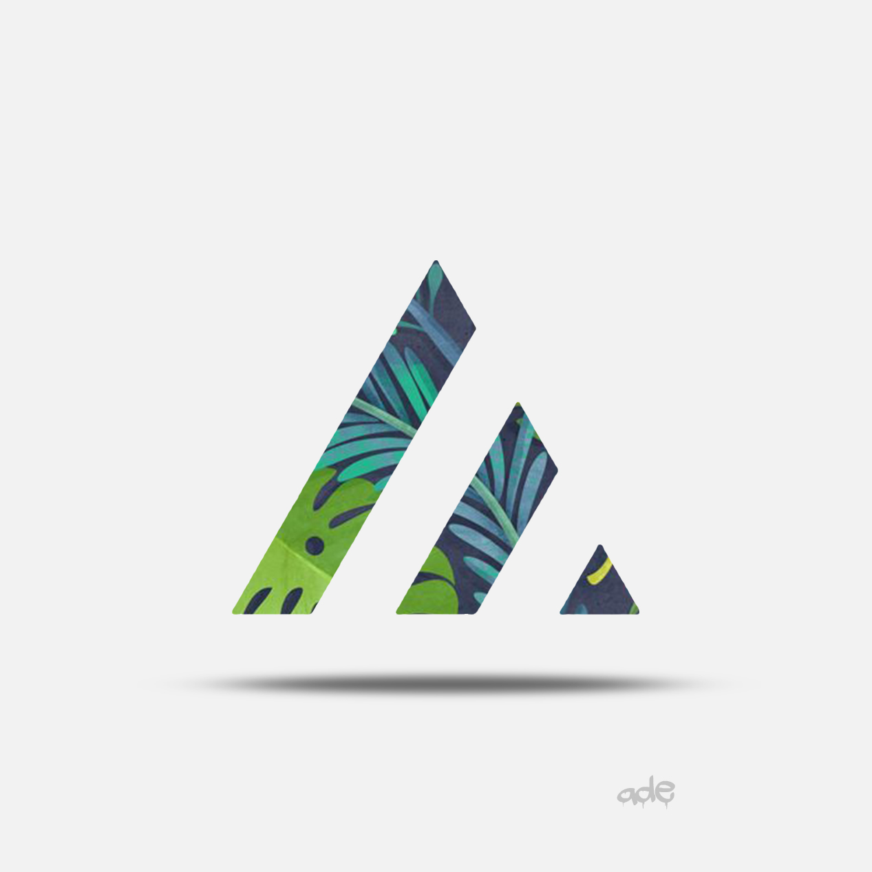 Abstract logo with three geometric shapes filled with tropical leaf patterns, with a shadow beneath and the word 'ade' in small font below.