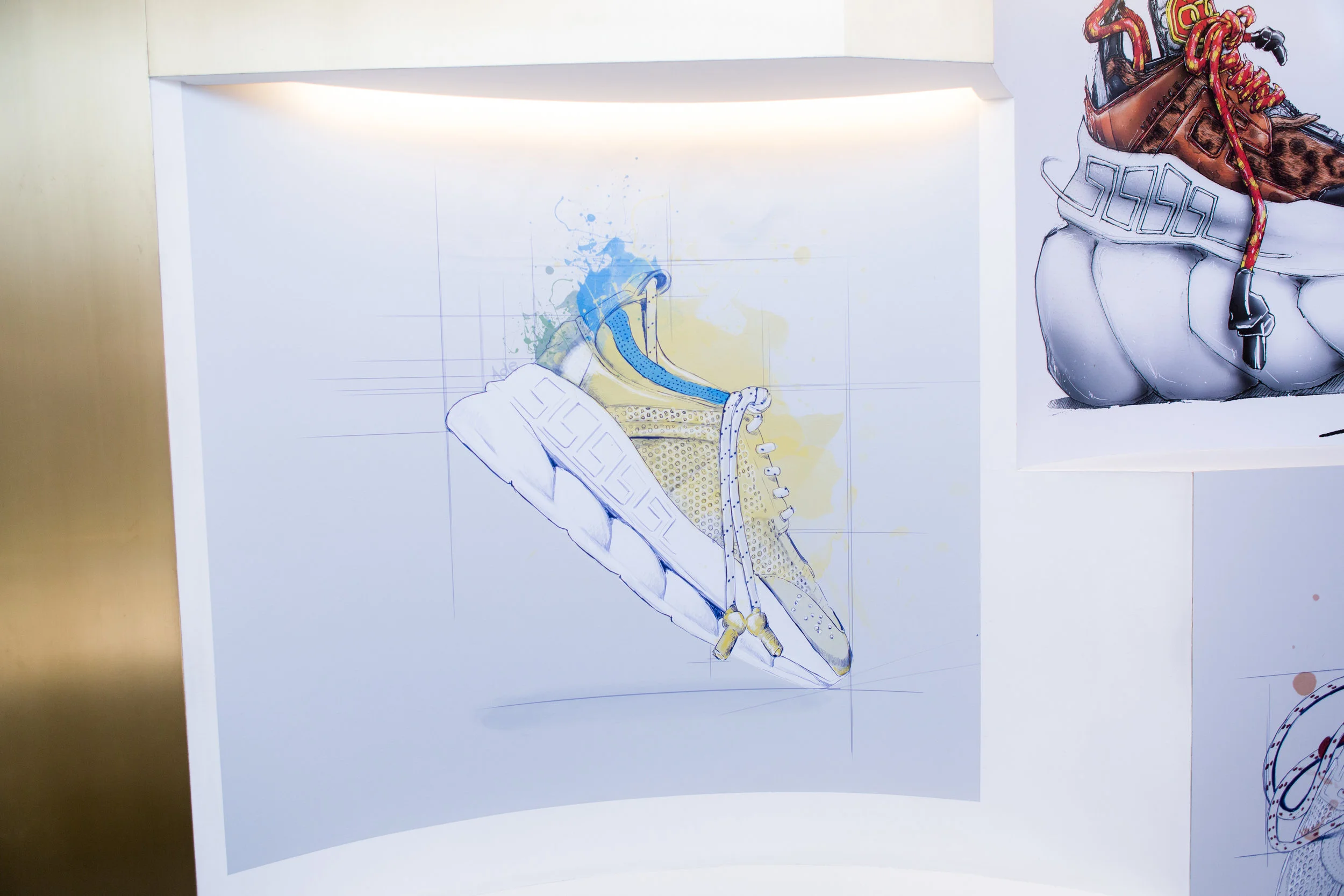 Sketch of a yellow and blue sneaker on a white background with colorful paint splashes.