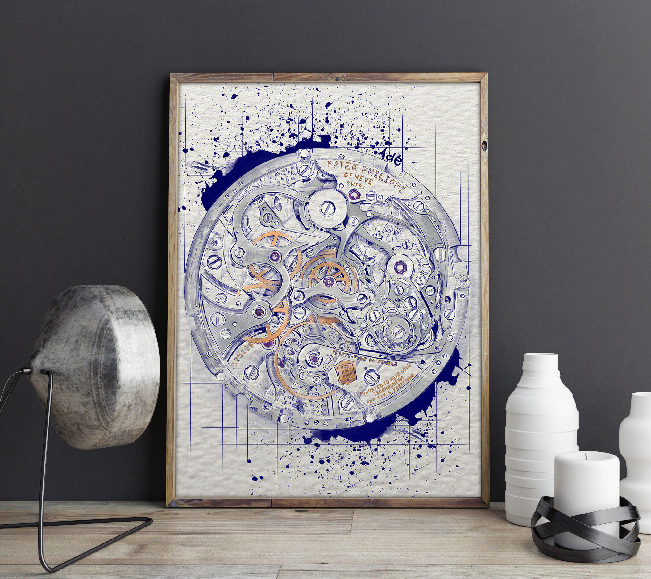 Art print of a watch movement with blue and orange details, framed and leaning against a dark gray wall, with decorative vases and a lamp on a light wood surface.
