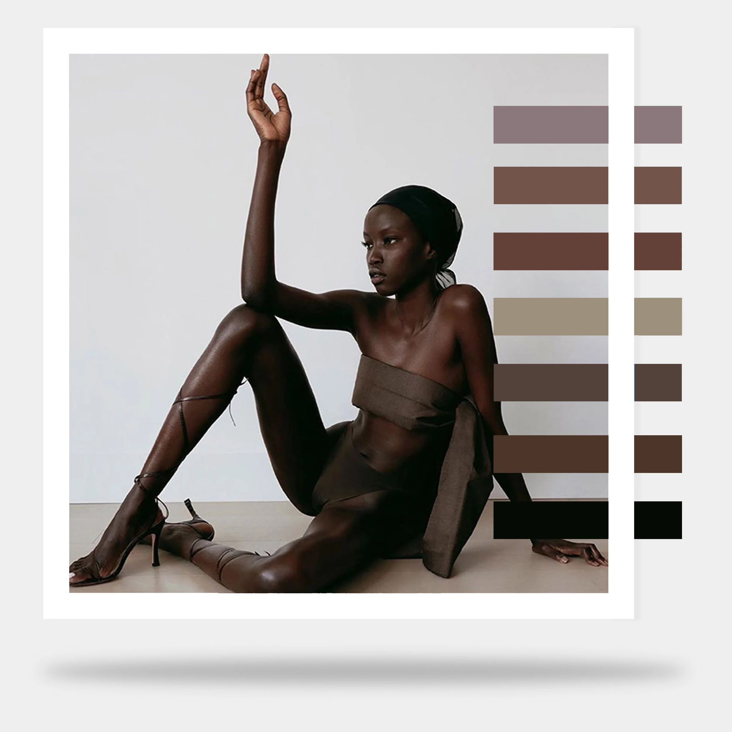 A dark-skinned woman wearing a black headwrap, sheer brown dress, and high heels poses on a plain background, brother vellies, aurora james