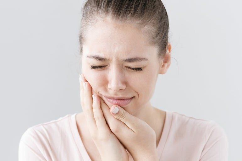 woman with sensitive teeth after cleaning
