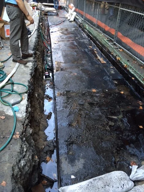  Open street, re-waterproof building electrical vault to water leakage and pour back new concrete vault.   New side walk curbs installation and asphalt as required outside Bryant Park.&nbsp;    
