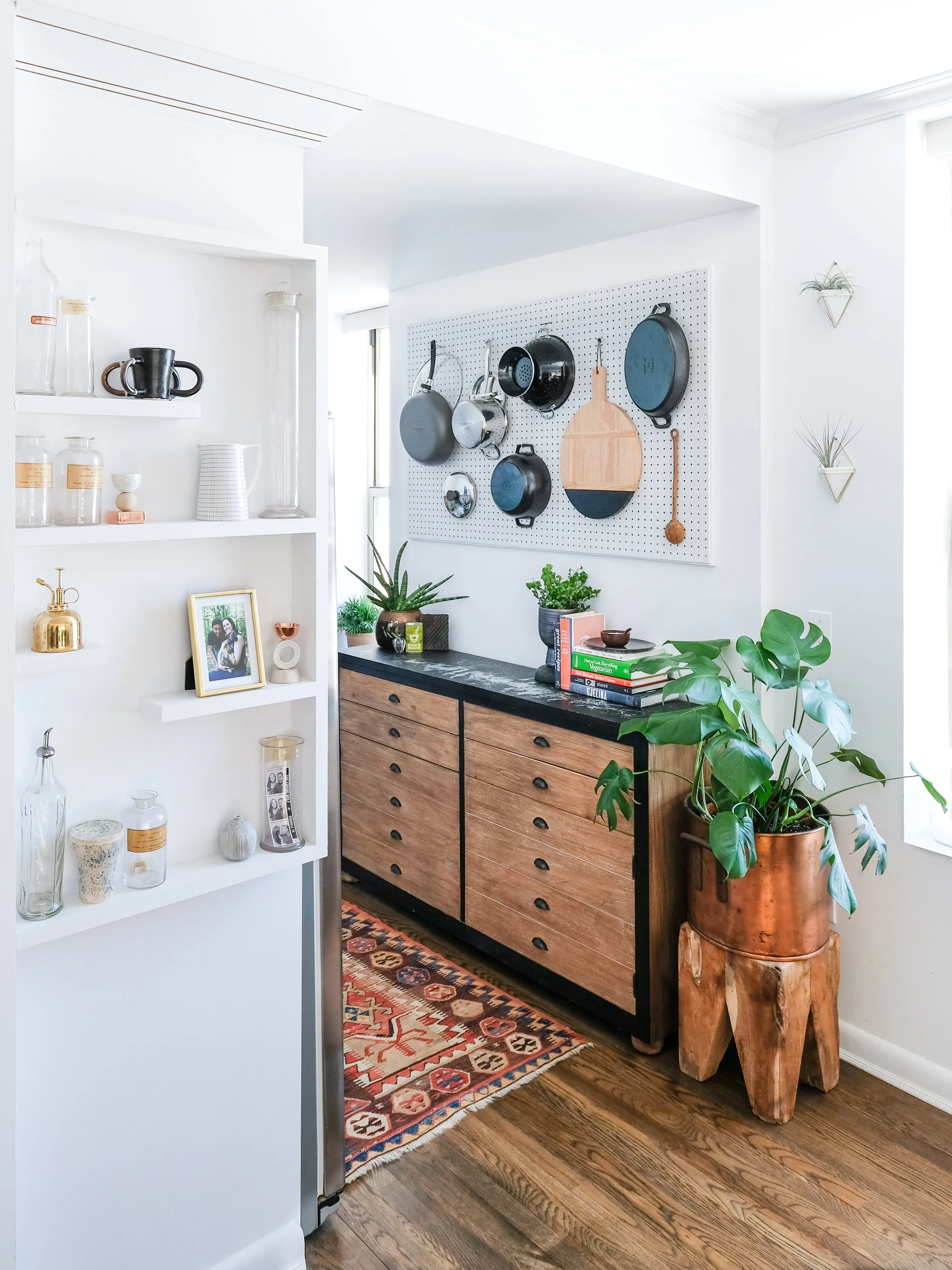 A wider shot of my display shelves and kitchen entrance. I loved the woodblock stool so much that I bought two. Good thing because they sold out! My white wall planters that I use as air plant holders are also a UO find. The white ones are no longer available, but you can find similar planters here .