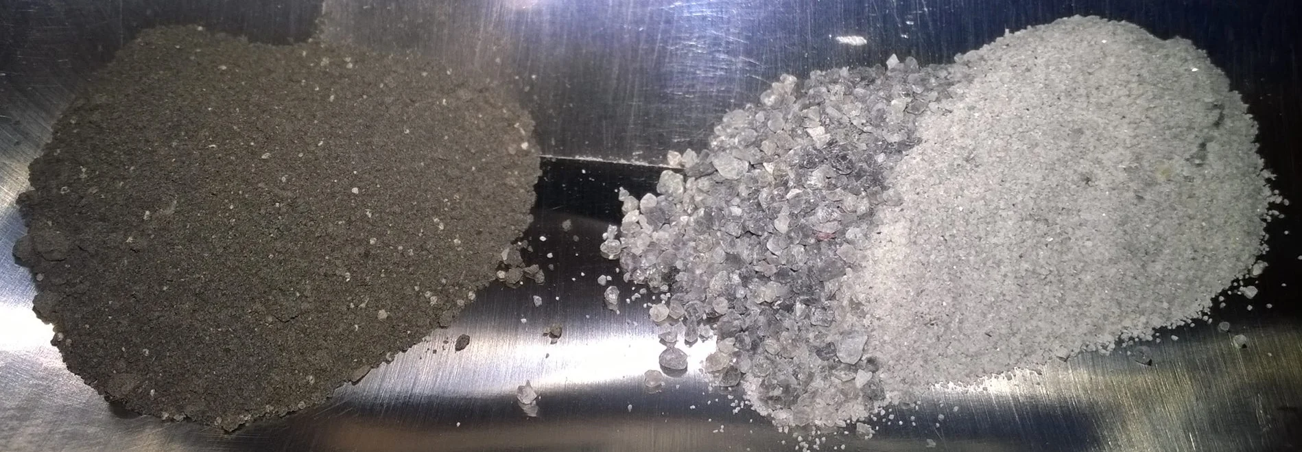 In this picture you can see two of the primary feedstocks we use for some of our simulants; basaltic cinder from the San Francisco formation in Arizona (left) and Shawmere anorthosite (right).