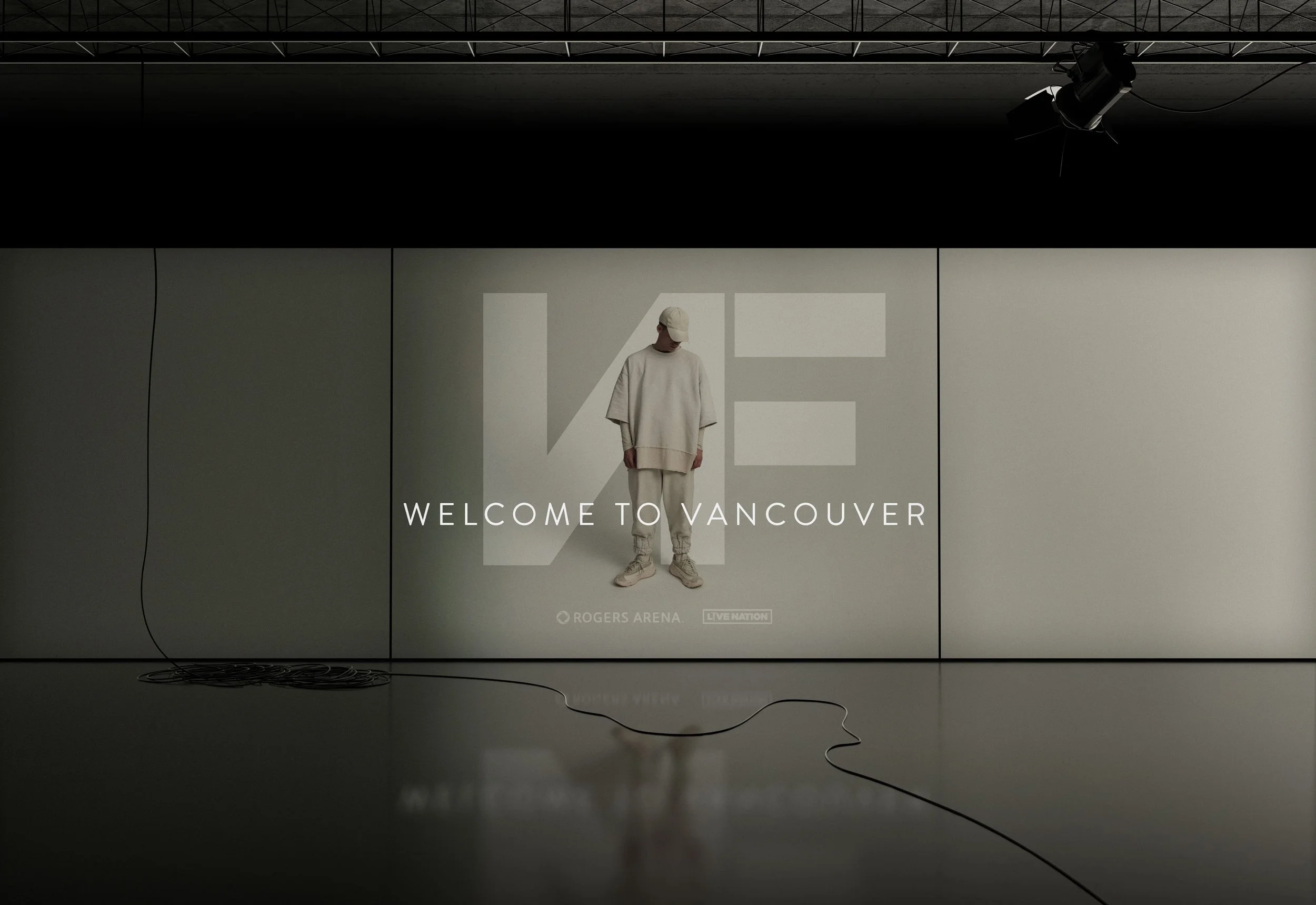 Welcome to Vancouver sign with a person in hoodie and cap against a backdrop of abstract geometric shapes, Rogers Arena, Live Nation logos.