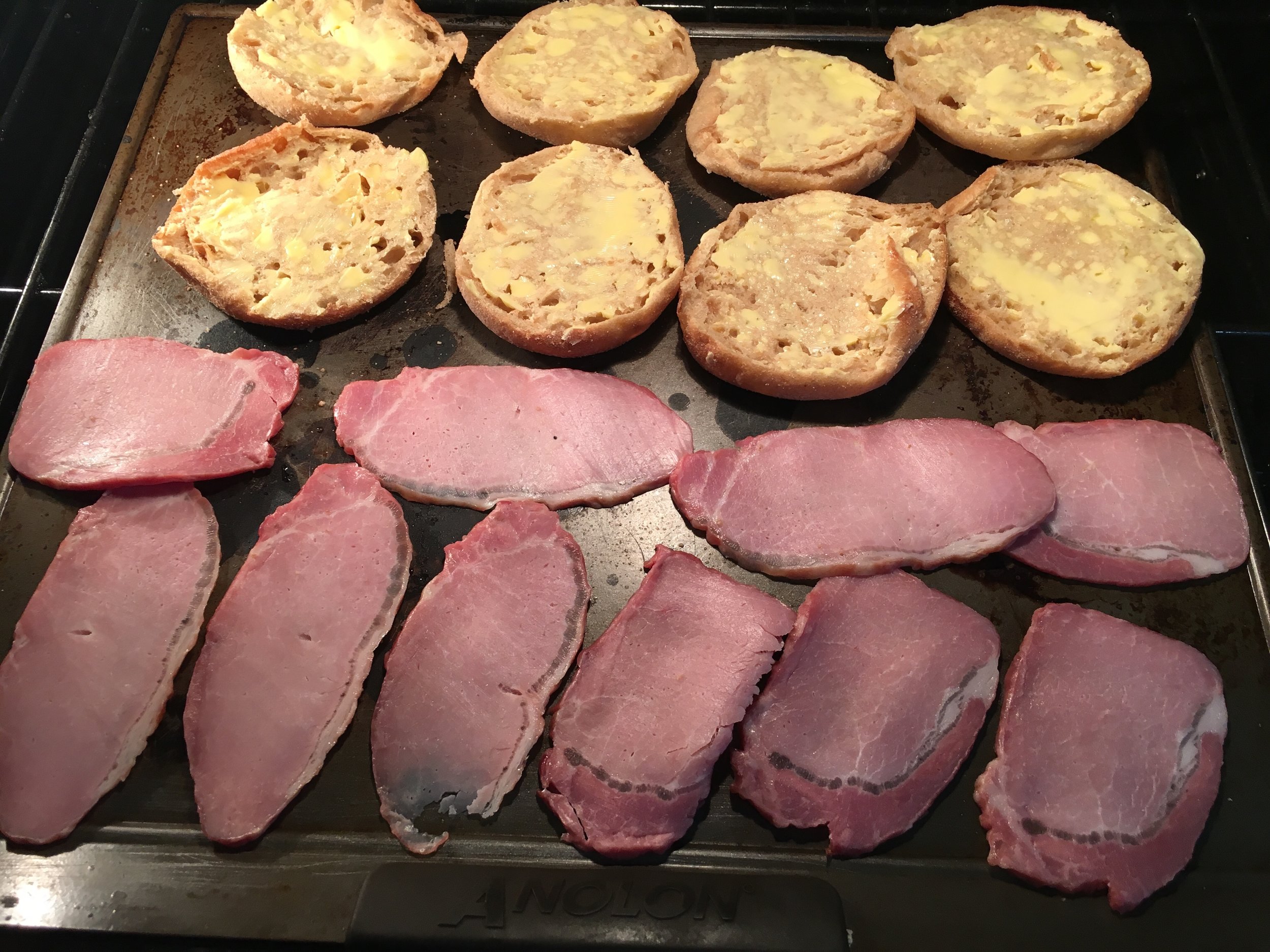 Broil the buttered English Muffins and Canadian Bacon