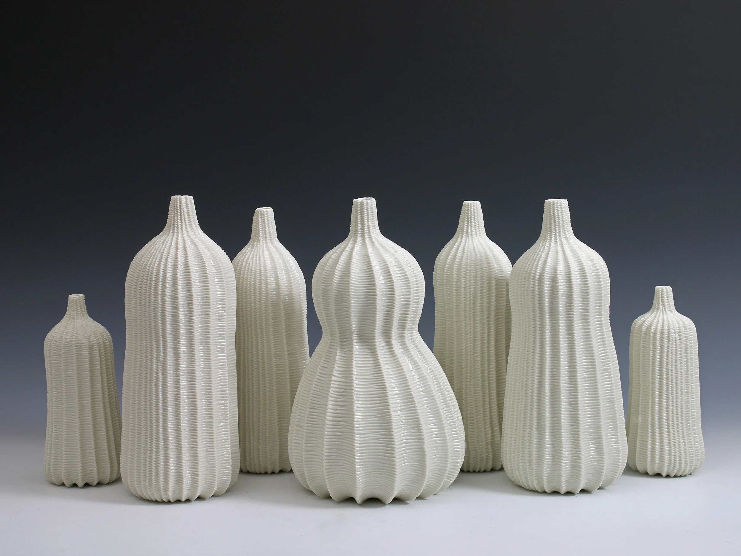 Garniture Of Seven Vases, 2015. Thrown and carved porcelain, height 26cm