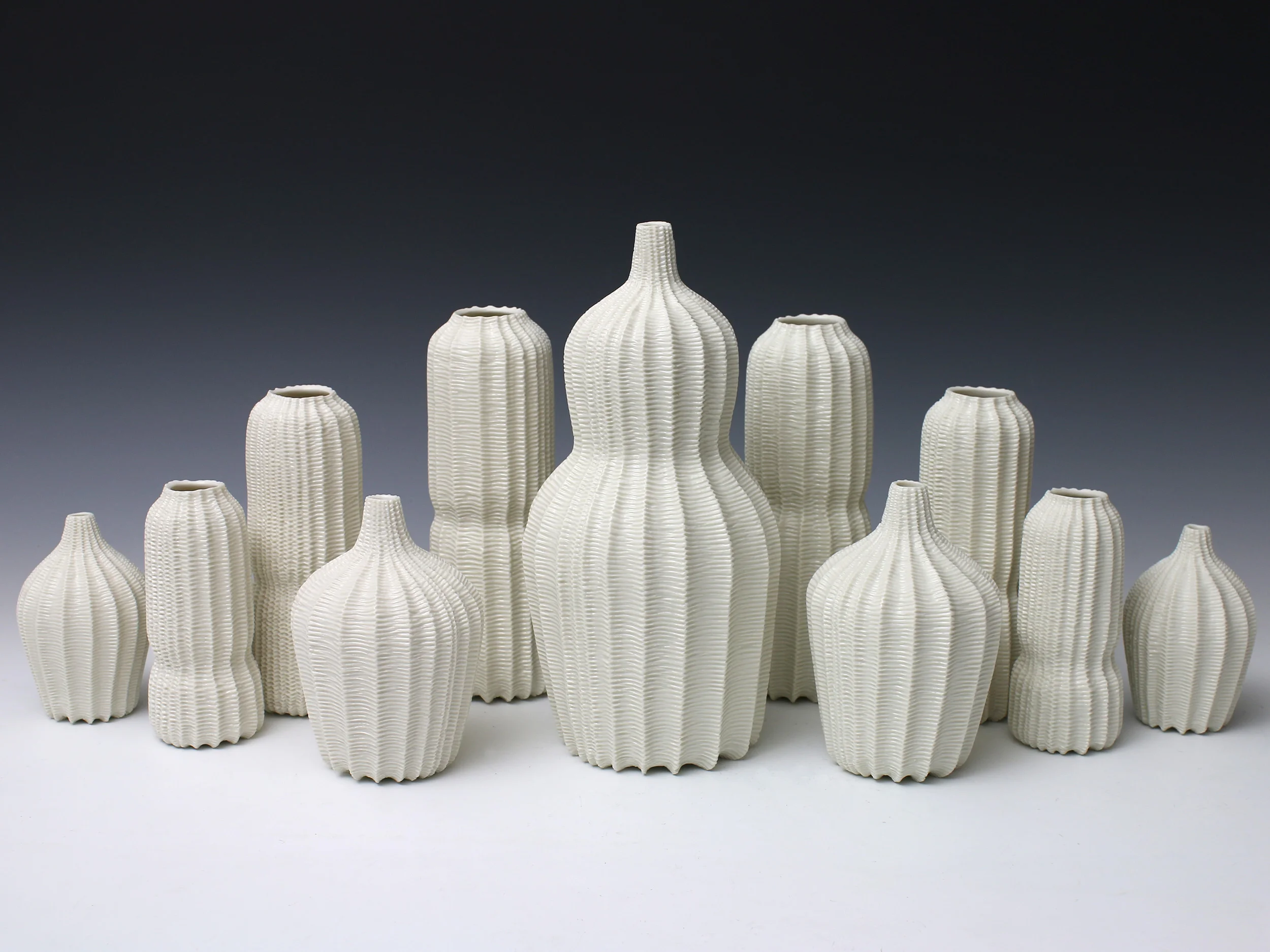 Garniture of Eleven Vases, 2015. Thrown and carved porcelain, height 27cm