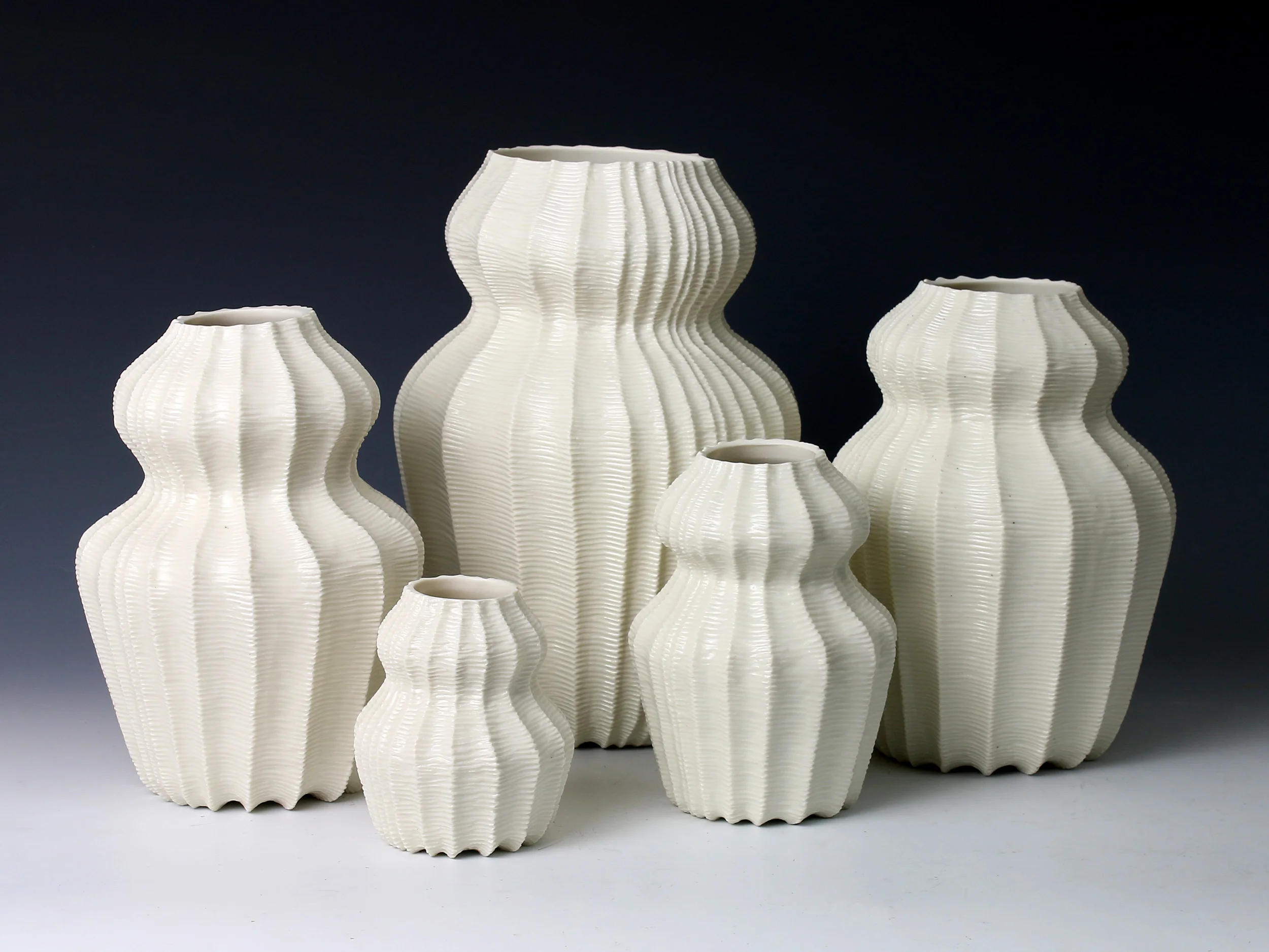 Five Hourglass Vases, 2015. Thrown and carved porcelain, height 25cm