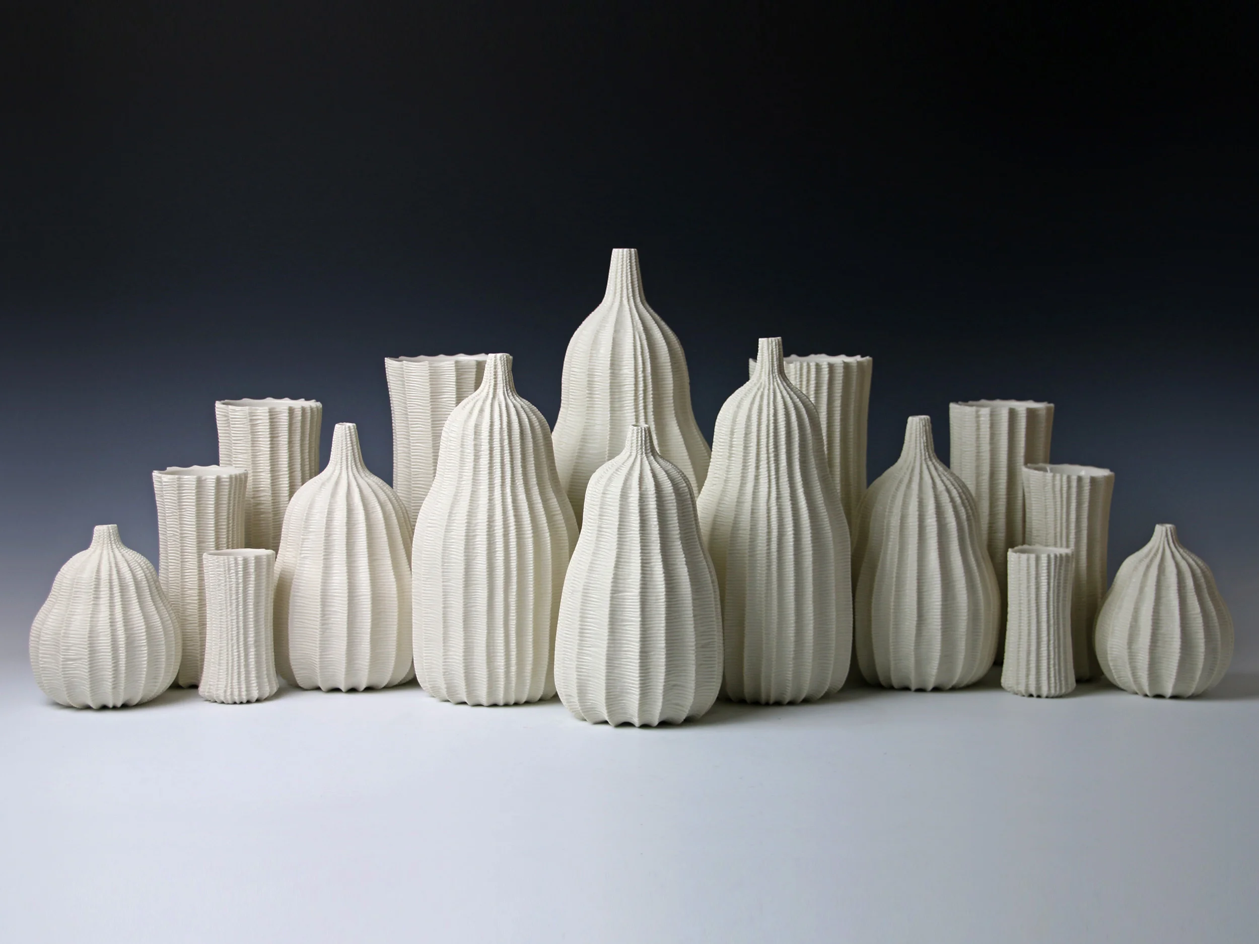 Garniture Of Sixteen Vases, 2014. Thrown and carved porcelain, height 34cm