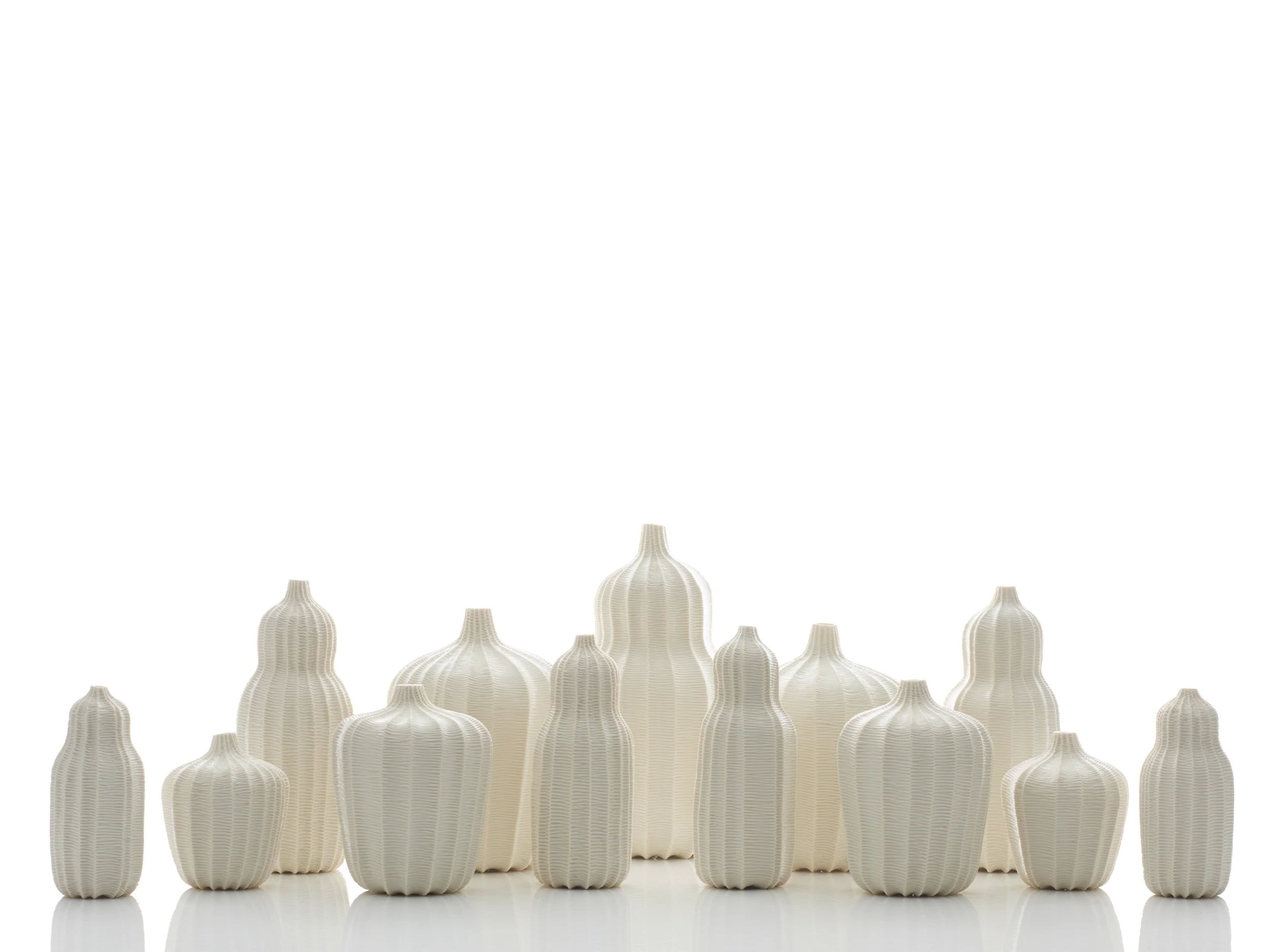 Garniture Of Thirteen Vases, 2015. Thrown and carved porcelain, height 31cm