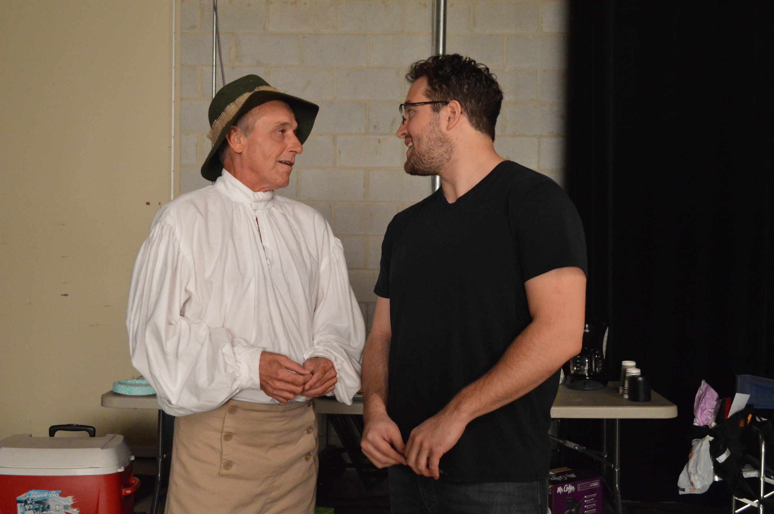 Actor Robin Robertson (left) dressed for one of his 7 roles, talking to Director Michael Duni (right).jpg