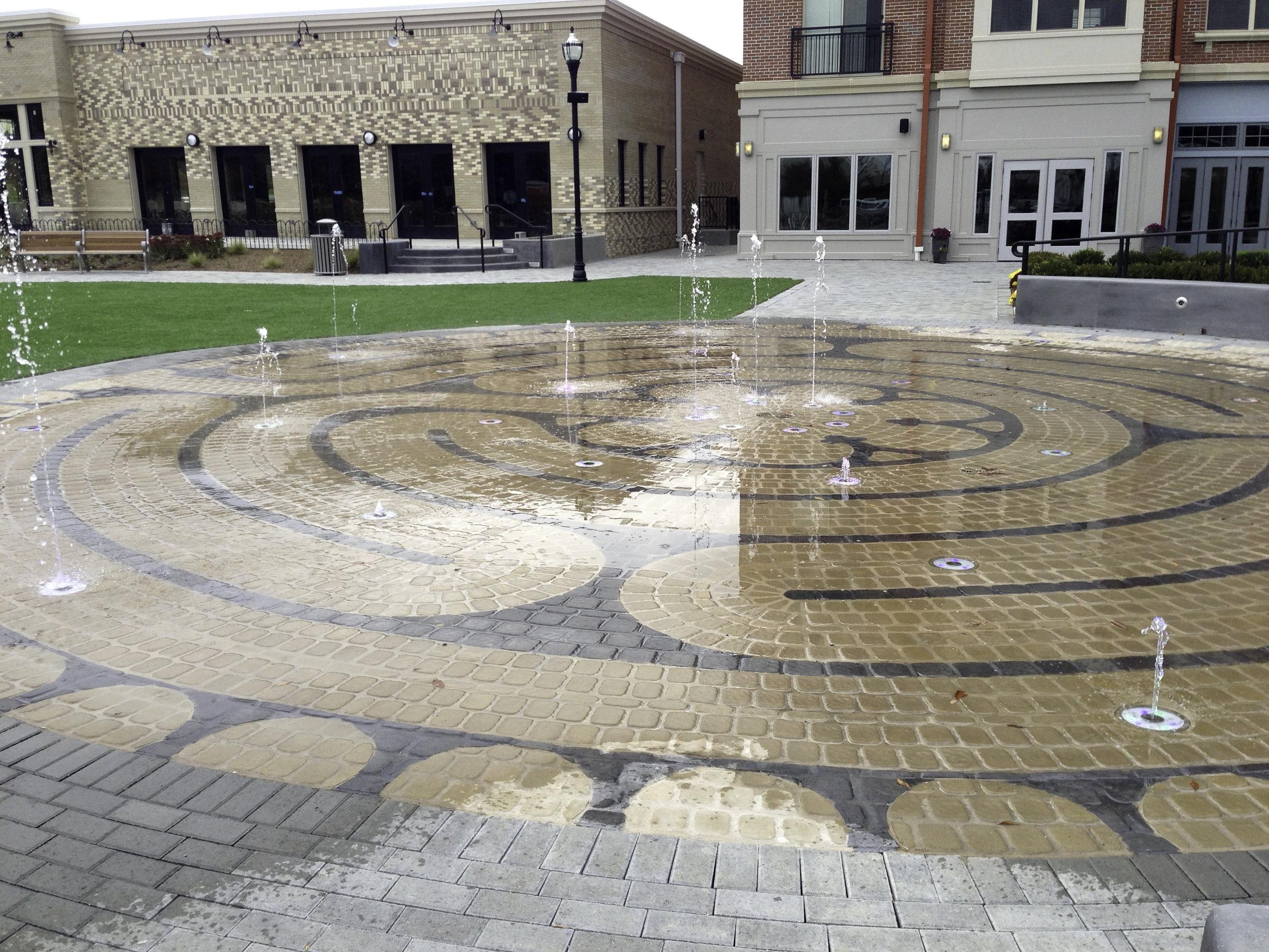 image of a fountain with artificial turf installation