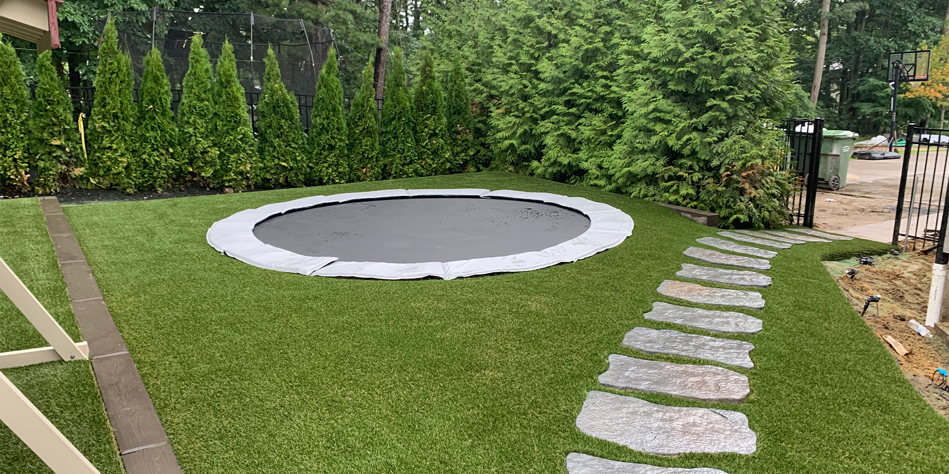 image of artificial grass installation around a trampoline