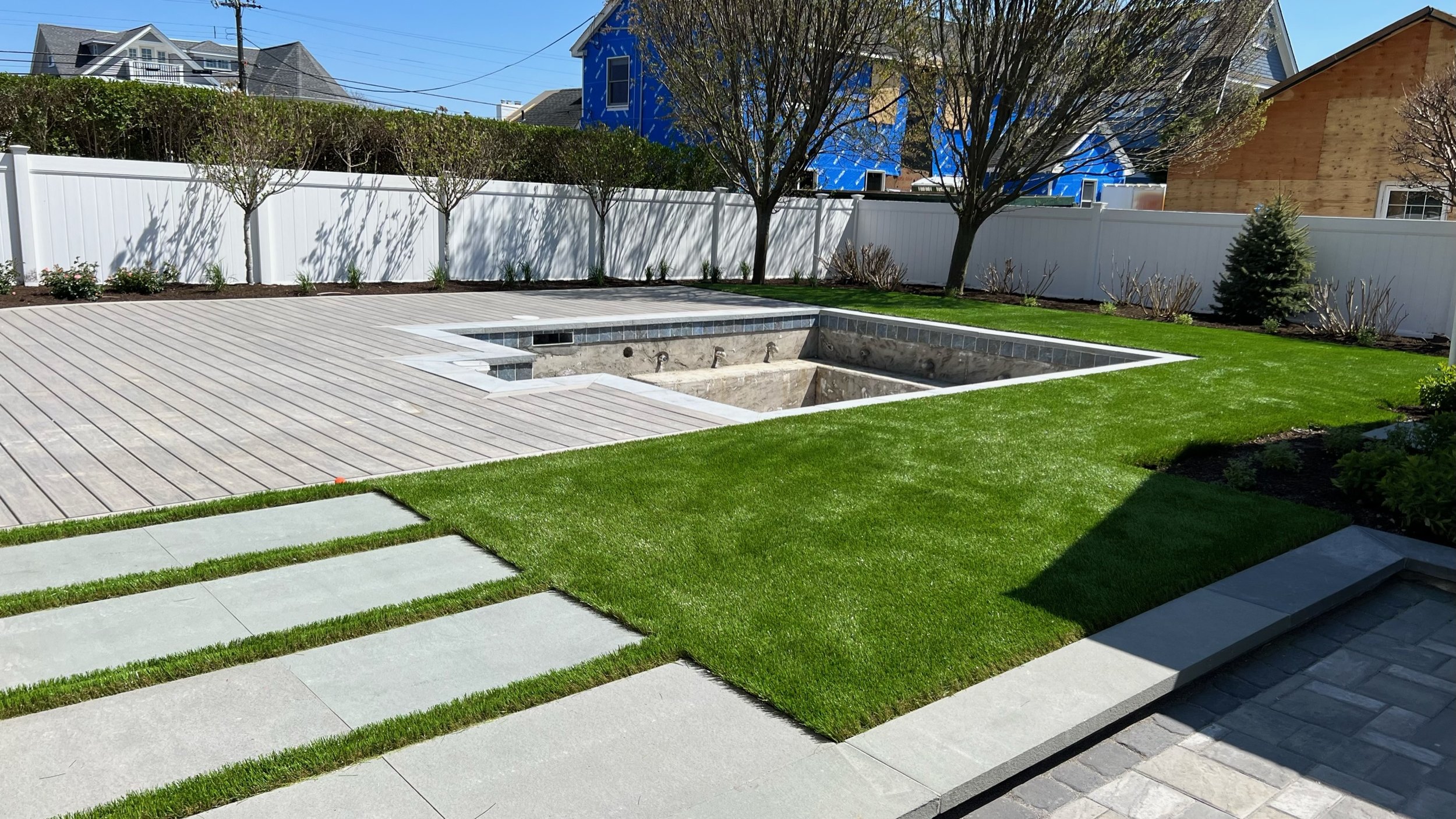 image of a residential backyard with artificial grass