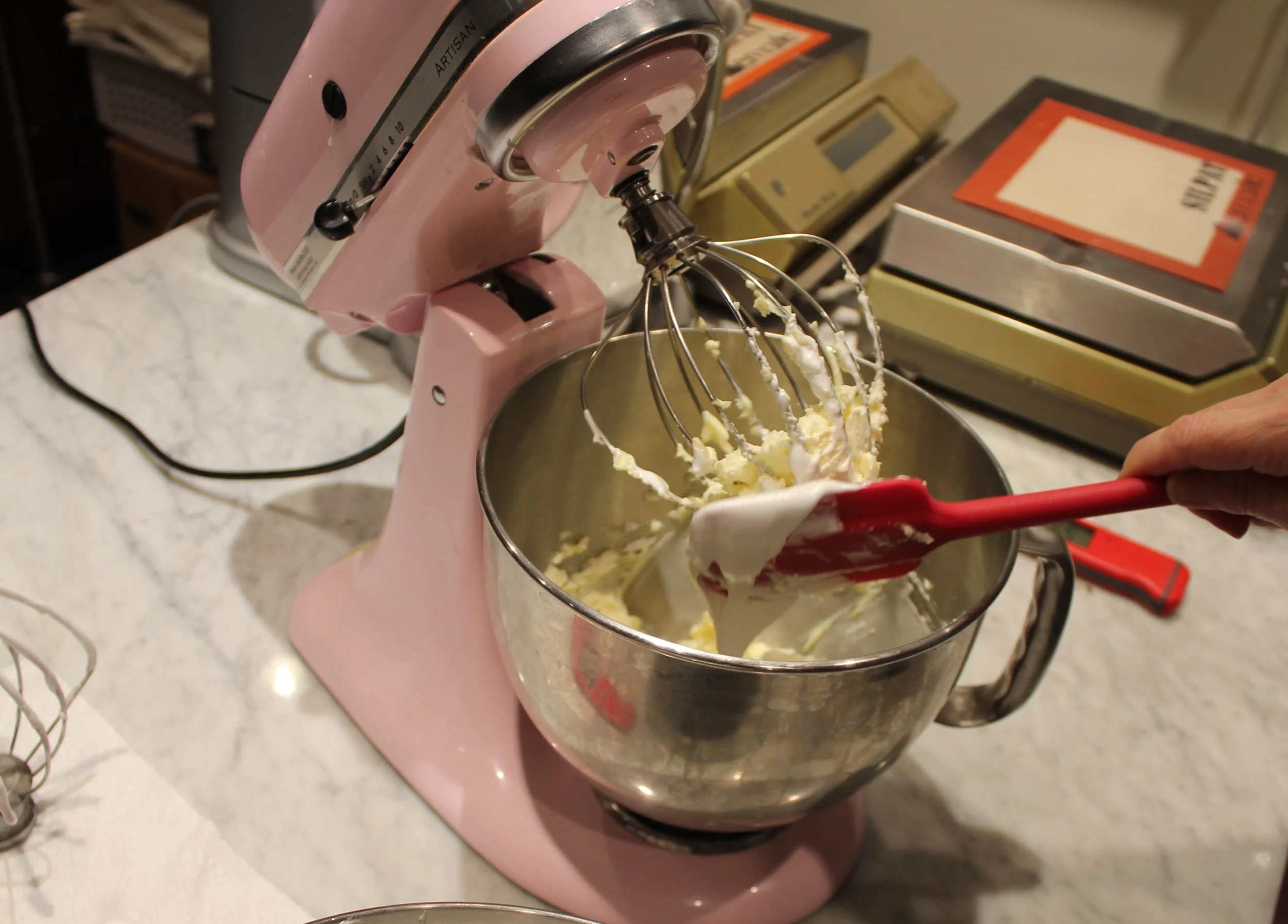 8) adding the Italian meringue to the creamed butter