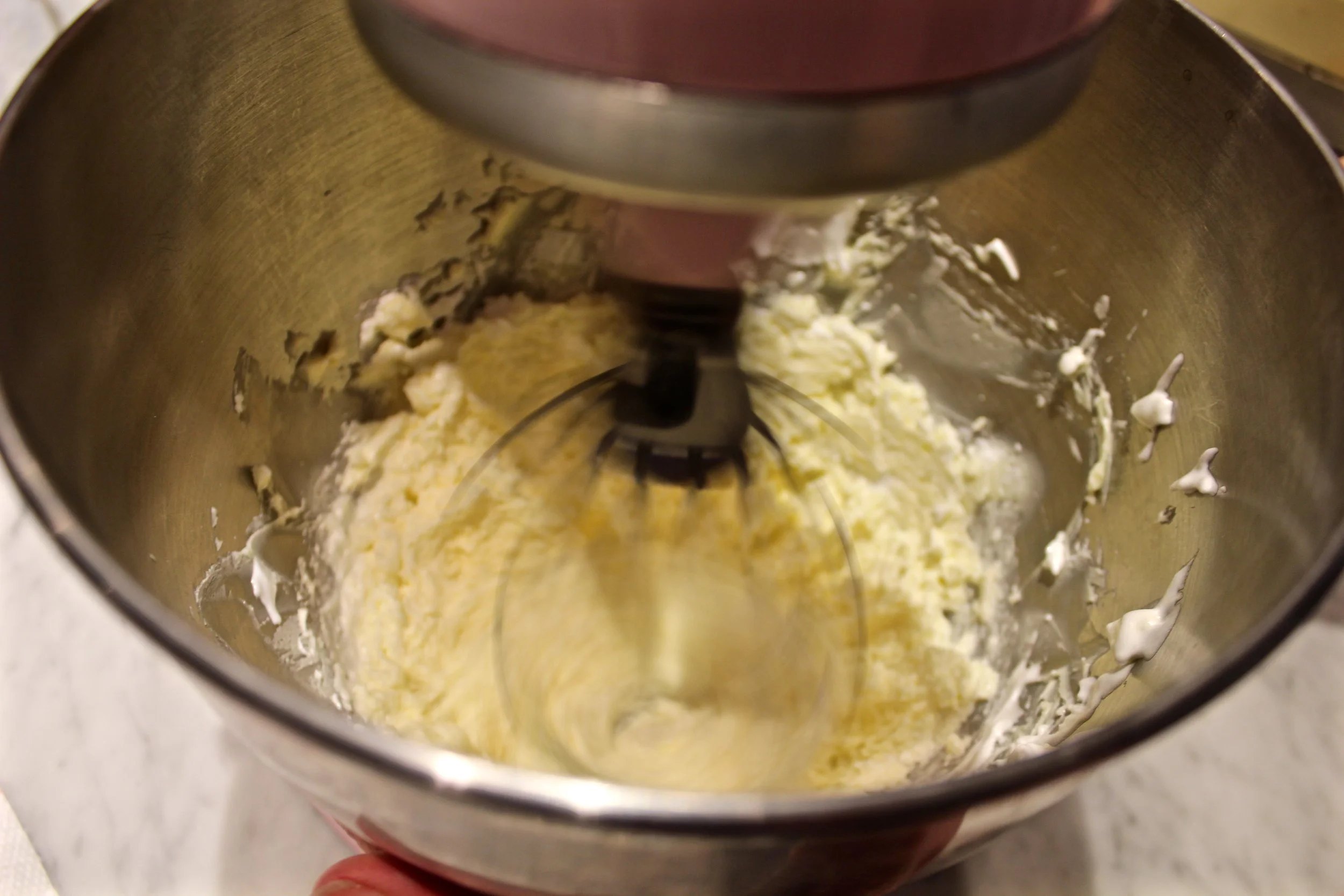 8) beating the butter and meringue to incorporate