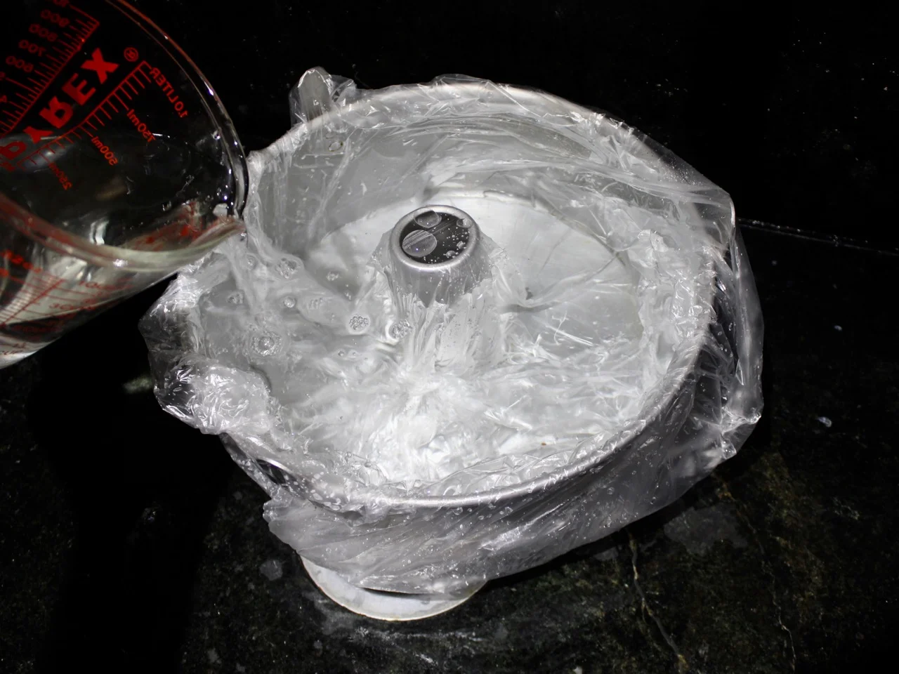16 CUP 2-PIECE PAN with trash bag liner being filled with water