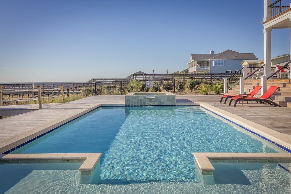 An aesthetic swimming pool with benches outside.