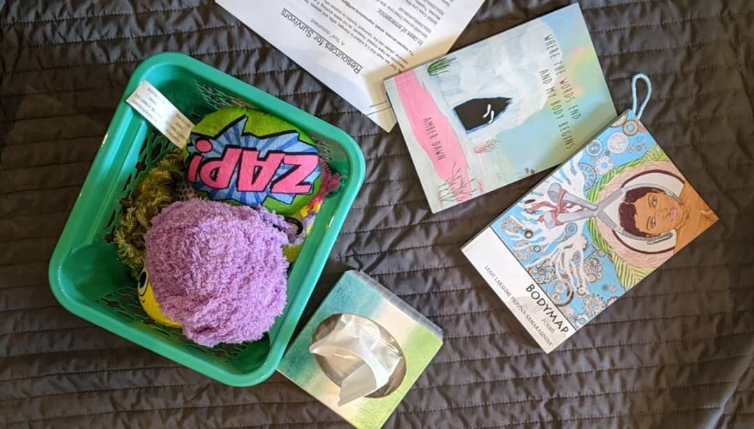 Some event supplies: fidget bucket for self-soothing, and resources for survivors