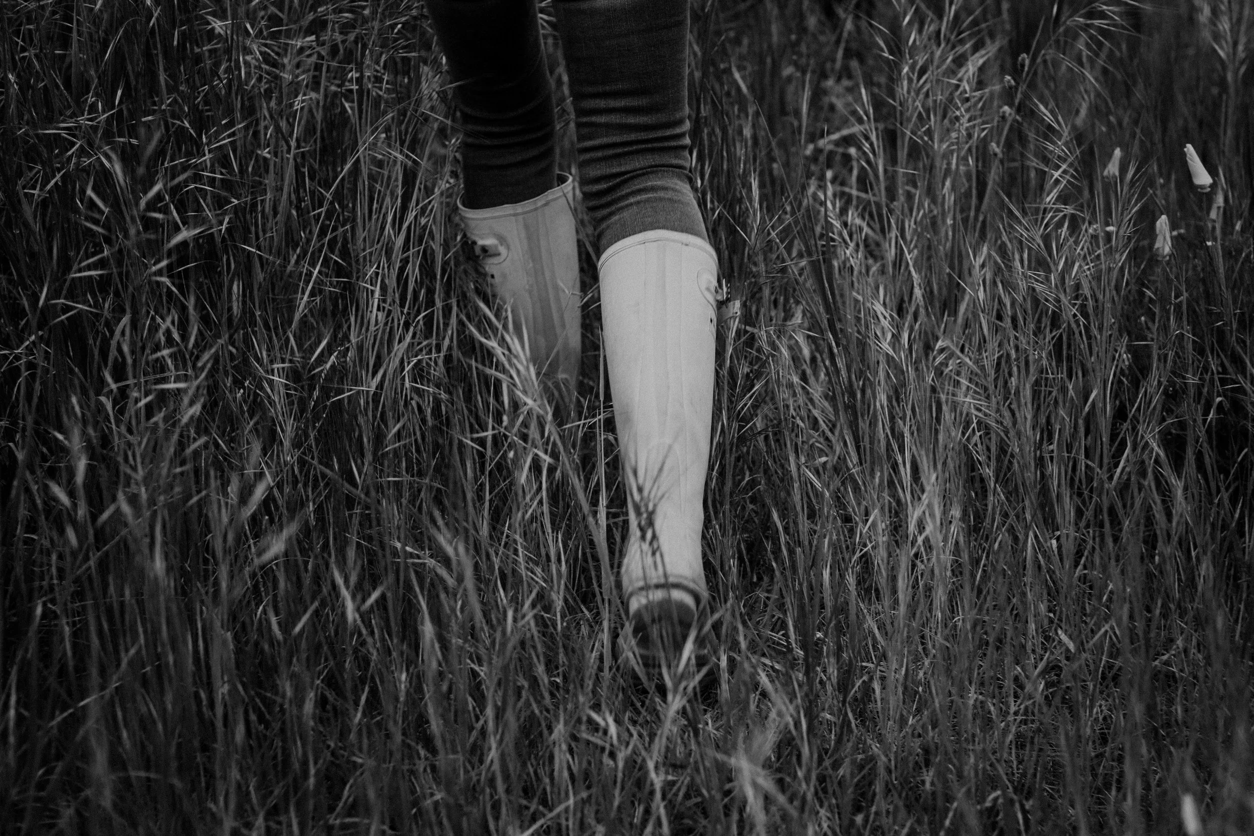 Rachel walking in wellies through the grass image