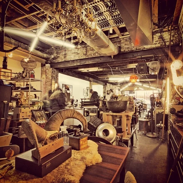 The bustling interior of the Space Lab Vancouver showroom filled with antiques, linking to the estate liquidation and downsizing services page.