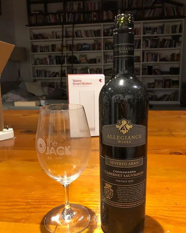 Nothing says @SizzleTownPodcast and @hamishandandy on a lockdown Saturday night like a bottle of Allegiance wine  Severed Arms Cab Sav with an all new Telstra Smart Modem lurking in the midground ... in front of a wall of books I haven’t read! @hamishblakeshotz @andytomlee