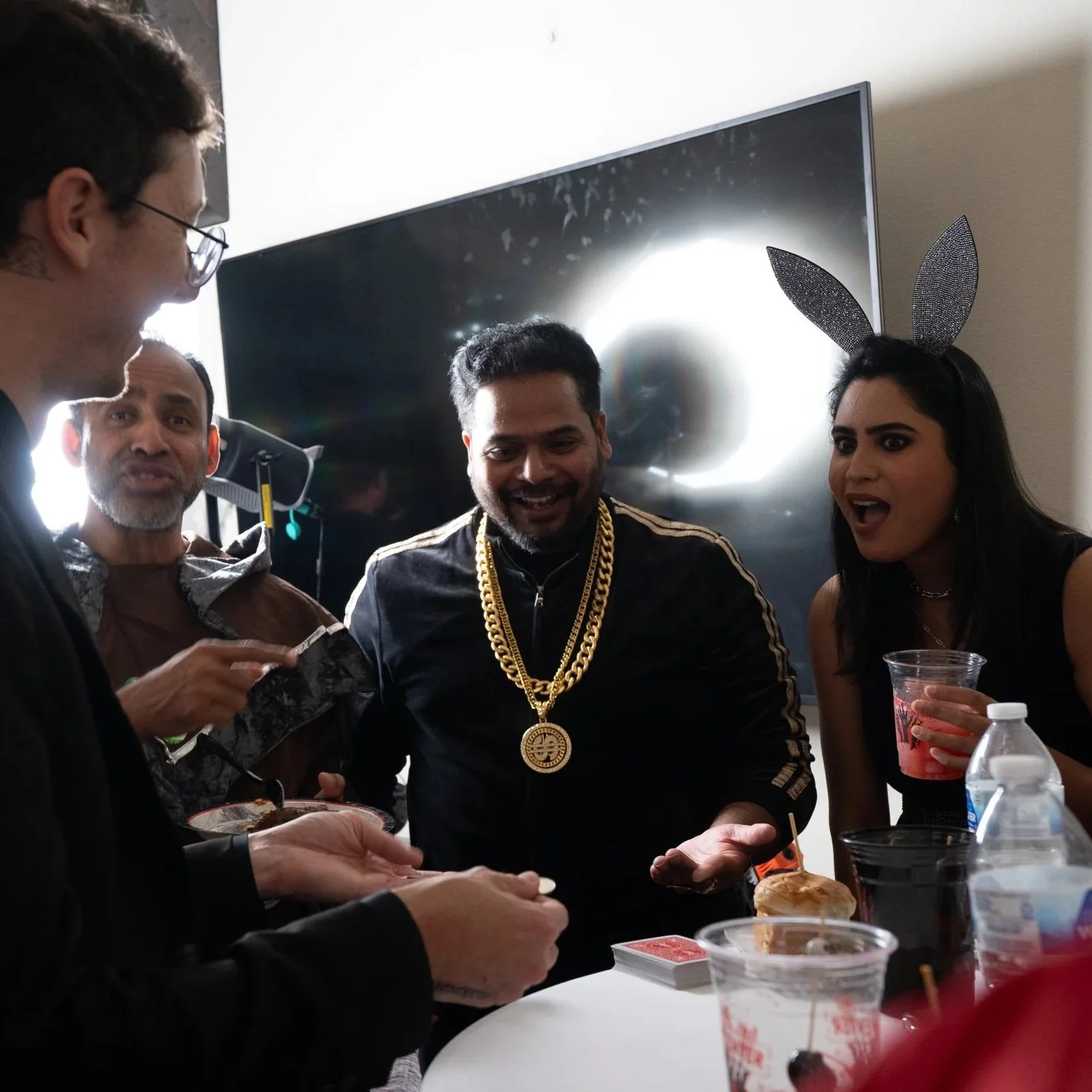 Houston wedding magician performing interactive close-up card magic and sleight of hand for guests at a reception table.