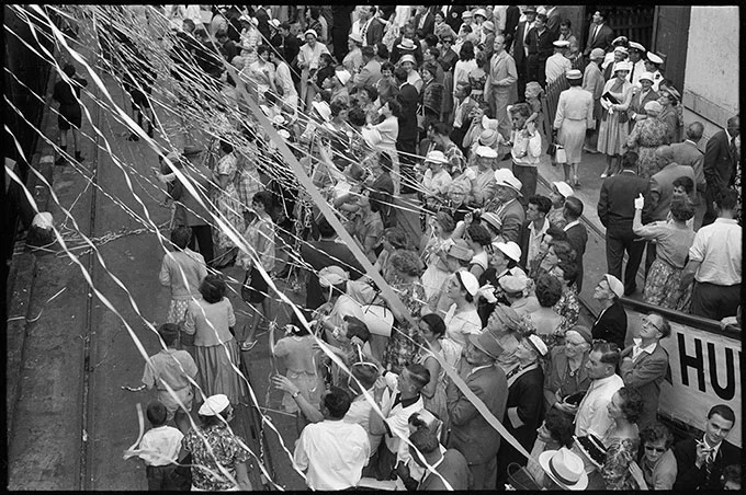 John Rykenberg, Crowds covered in streamers on the Auckland wharves for the departure of the MV Wanganella for Sydney , 1958.