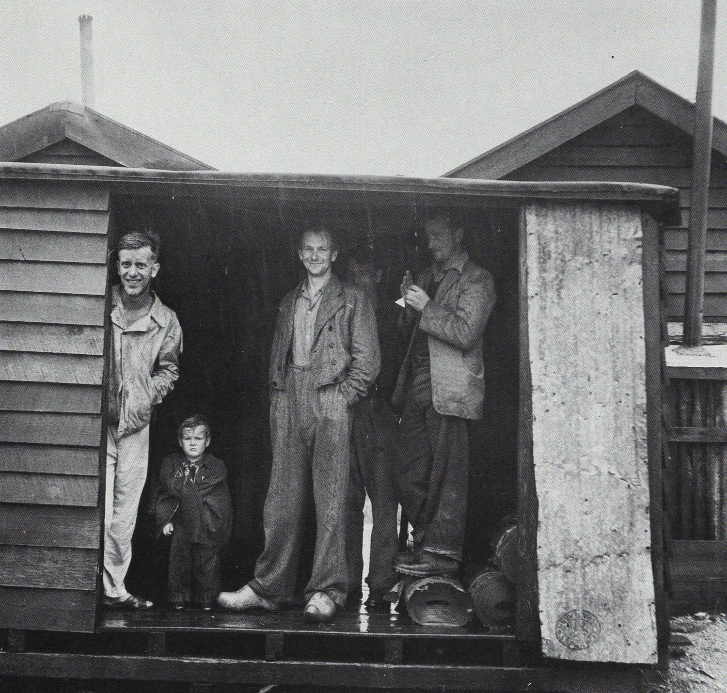 Les Cleveland. Silver Pine Cutters Sheltering From Rain at Mussell Point, South Westland , 1955. Witness to Change - Life in New Zealand Photographs 1940-1965 . PhotoForum/Wellington, 1985.