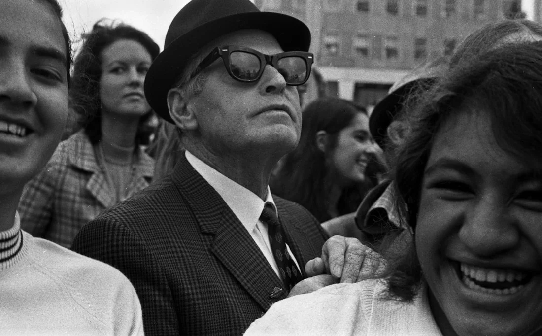Max Oettli: Man pushing through crowd, Auckland, 1972, silver-gelatin vintage print.
