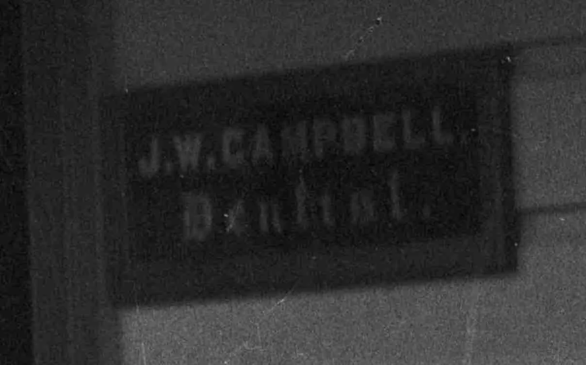 Detail of previous image. Sign next to door. Lemuel Lyes Collection.