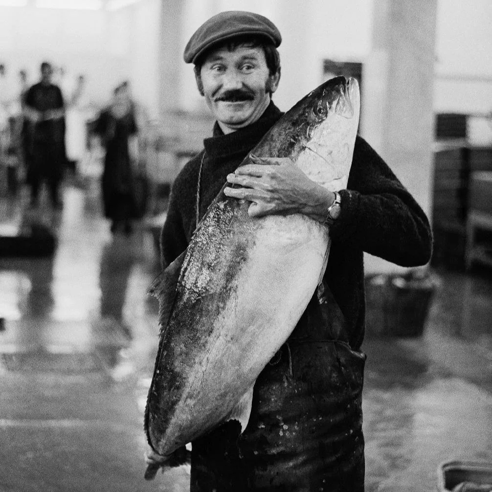 A Man Holds a Fish