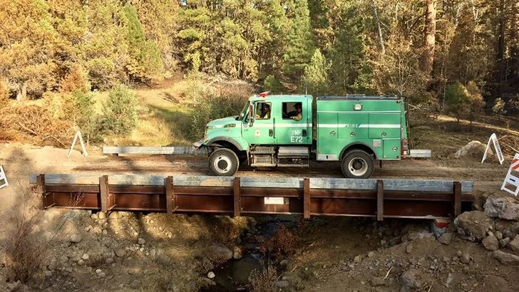 The first firefighters to cross the newly placed bridge. (USDA photo by Chris Bielecki)