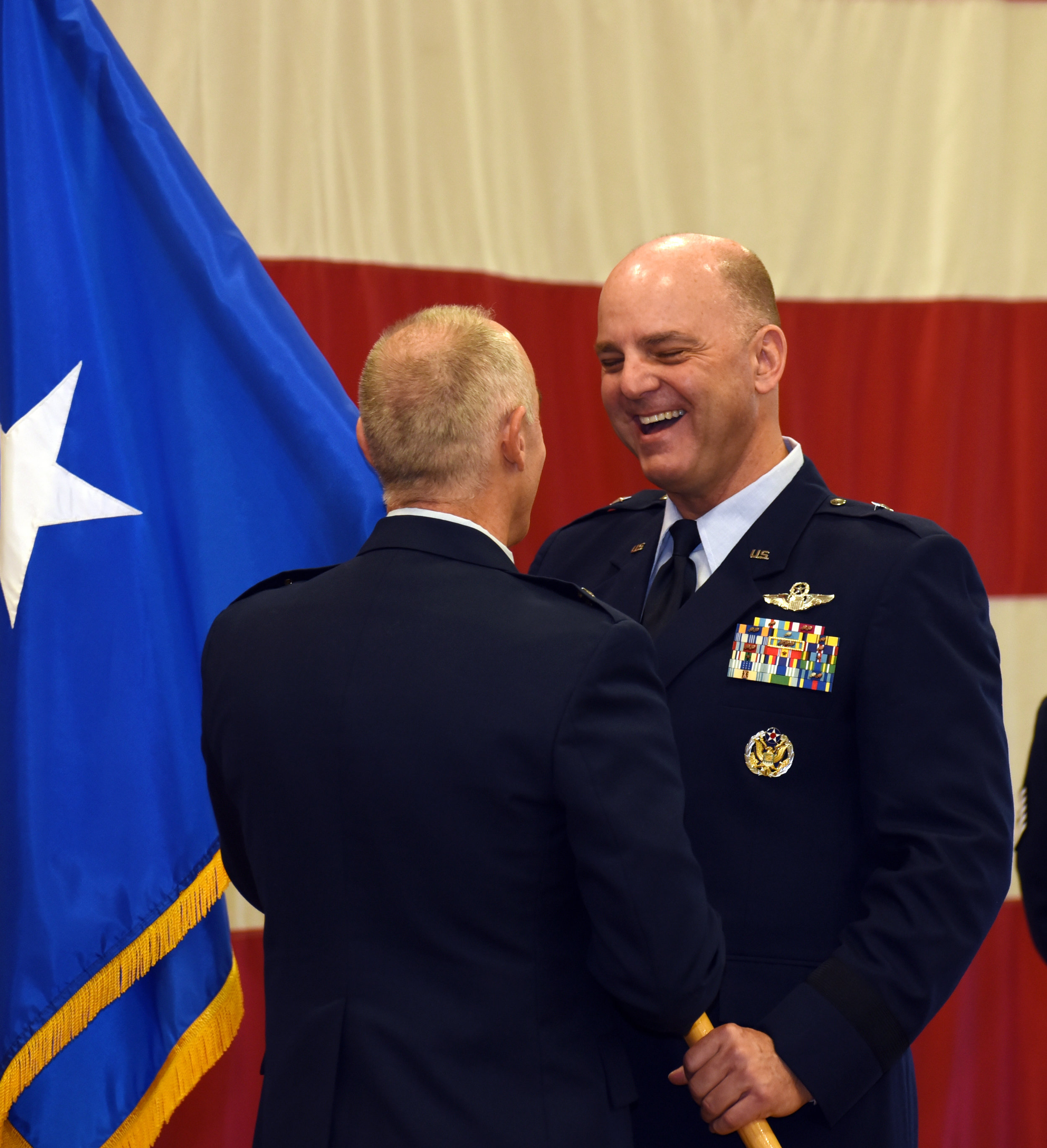  Brig. Gen. James R. Kriesel (right), incoming commander, Oregon Air National Guard, receives his one-star general officer flag from outgoing commander, Brig. Gen. Jeffrey M. Silver, during a promotion ceremony at the Anderson Readiness Center in Sal