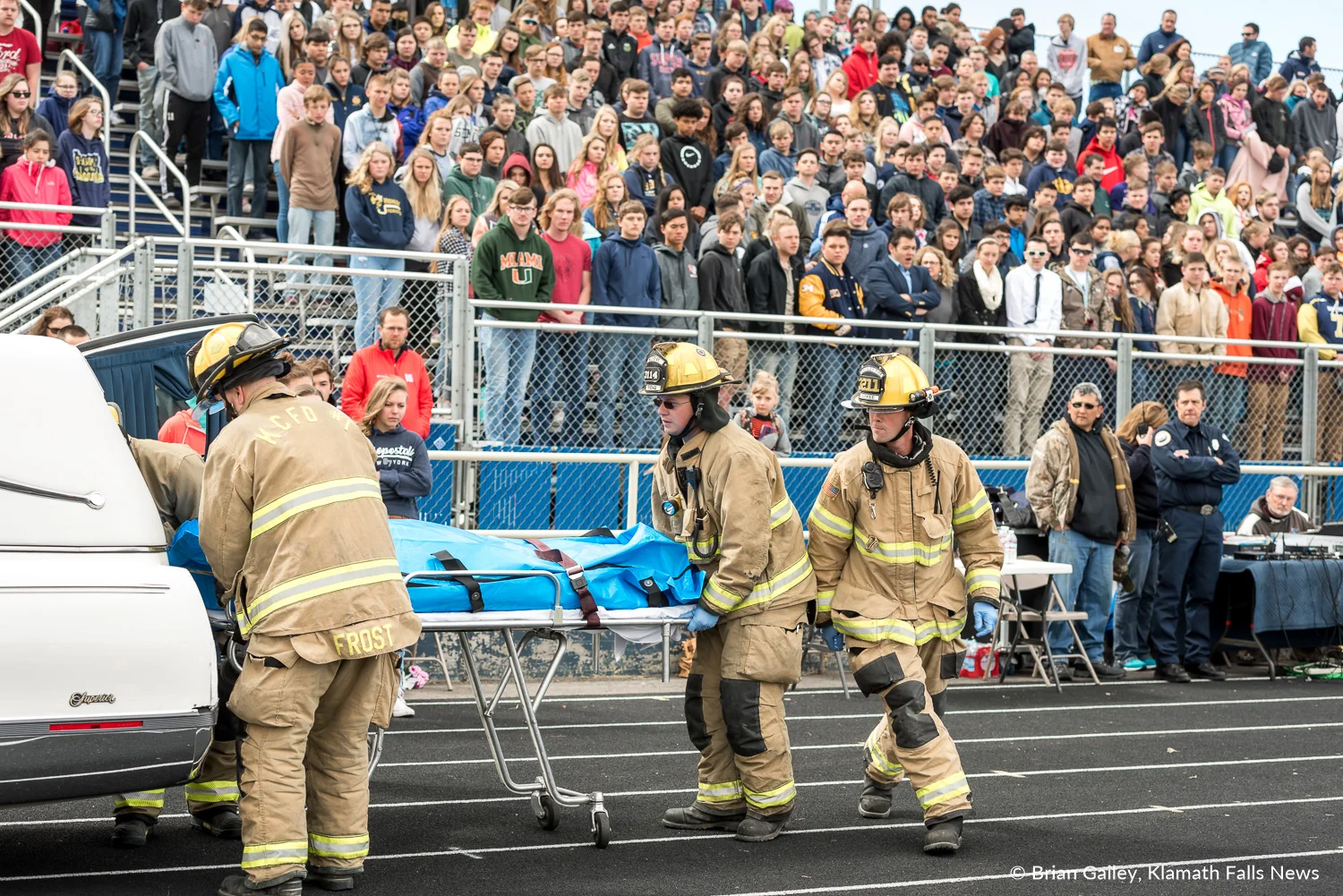 Operation Prom Night, a staged DUII car crash to teach teens the reality of drinking and driving. Kaila Mick, in the body bag, is loaded into the back of a hearse. First responders from KCSD1 are seen participating in the simulation as students look on. April 19, 2018 (Brian Gailey)