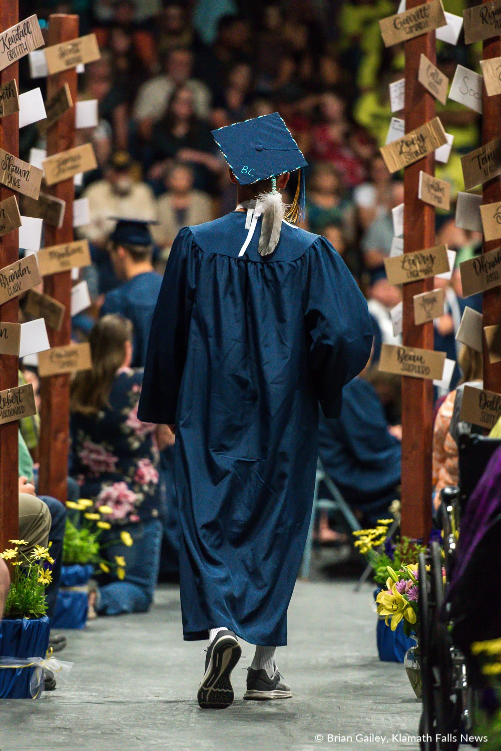 A graduate walks back to their seat after recieving a diploma at the Henley HS Graduation Ceremony. June 10, 2018 (Brian Gailey).