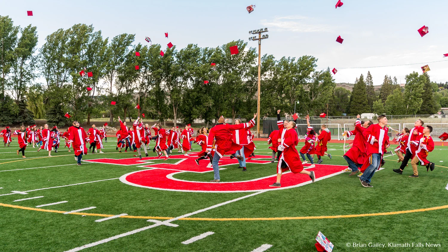 Keeping with tradition, the 2018 Senior Class celebrates mid field following the graduation ceremony. June 9, 2018 (Brian Gailey).
