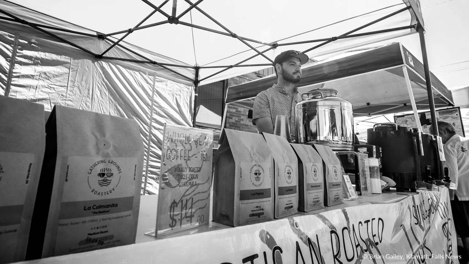 Jason Aarstad, Owner of Gathering Grounds Roastery offers locally roasted coffee at the Klamath Falls Farmers' Market. Aarstad also has a cafe located just down the street from the market. June 30, 2018 (Brian Gailey)
