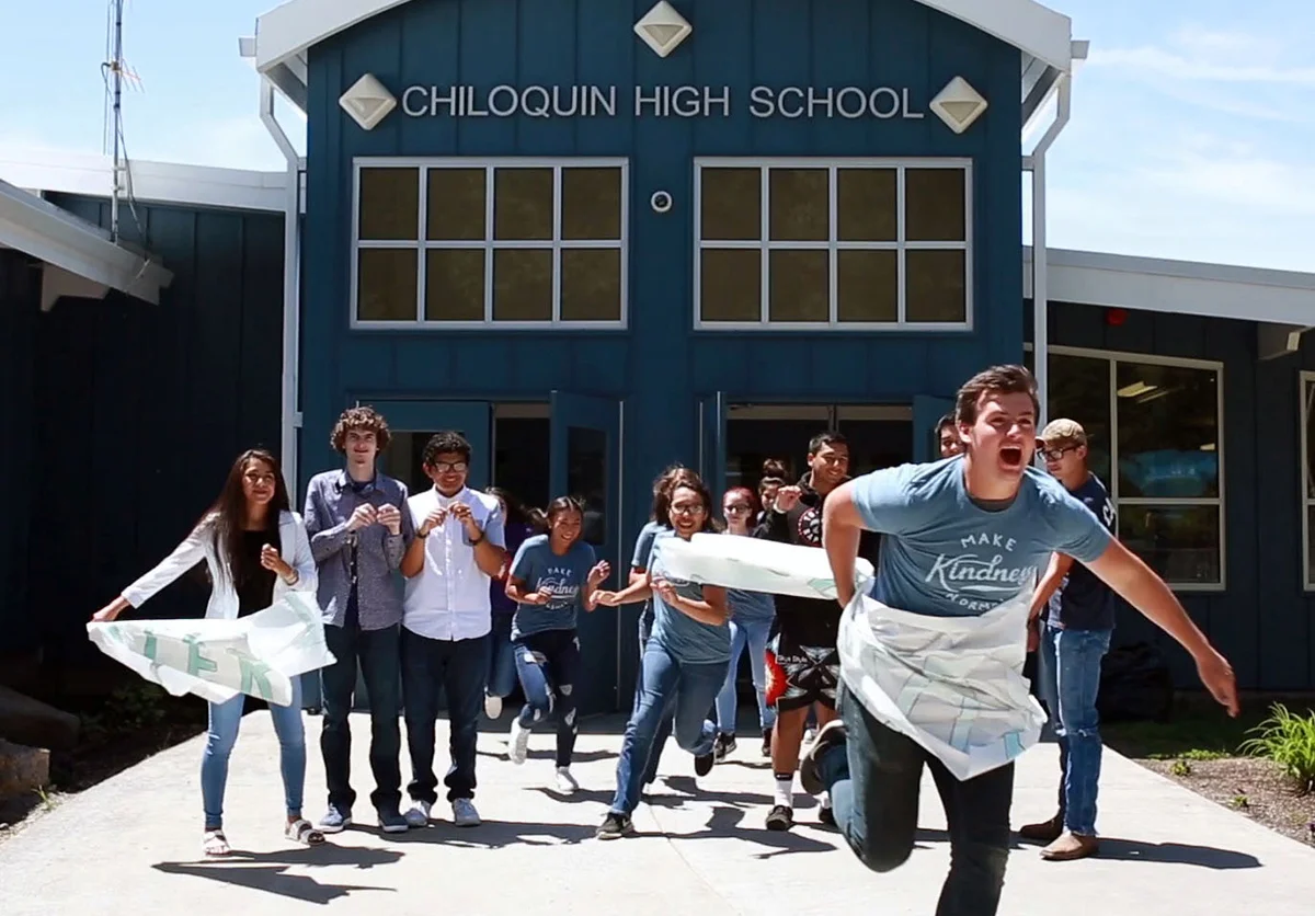 Busting through stereotypes: An image in a video created by Chiloquin leadership students last spring shows students running through a sign stating “Chiloquin stereotypes.