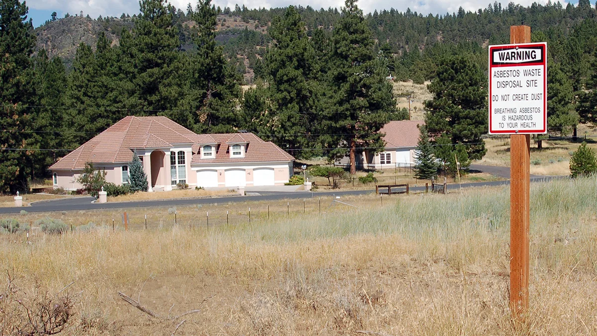 A sign bearing a warning about asbestos is shown in the North Ridge Estates subdivision in this 2010 photo.A sign bearing a warning about asbestos is shown in the North Ridge Estates subdivision in this 2010 photo.