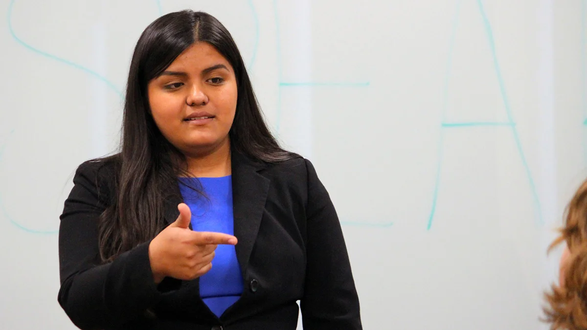 Ximena Lemus-Hernandez interacts with students during a workshop on public speaking.