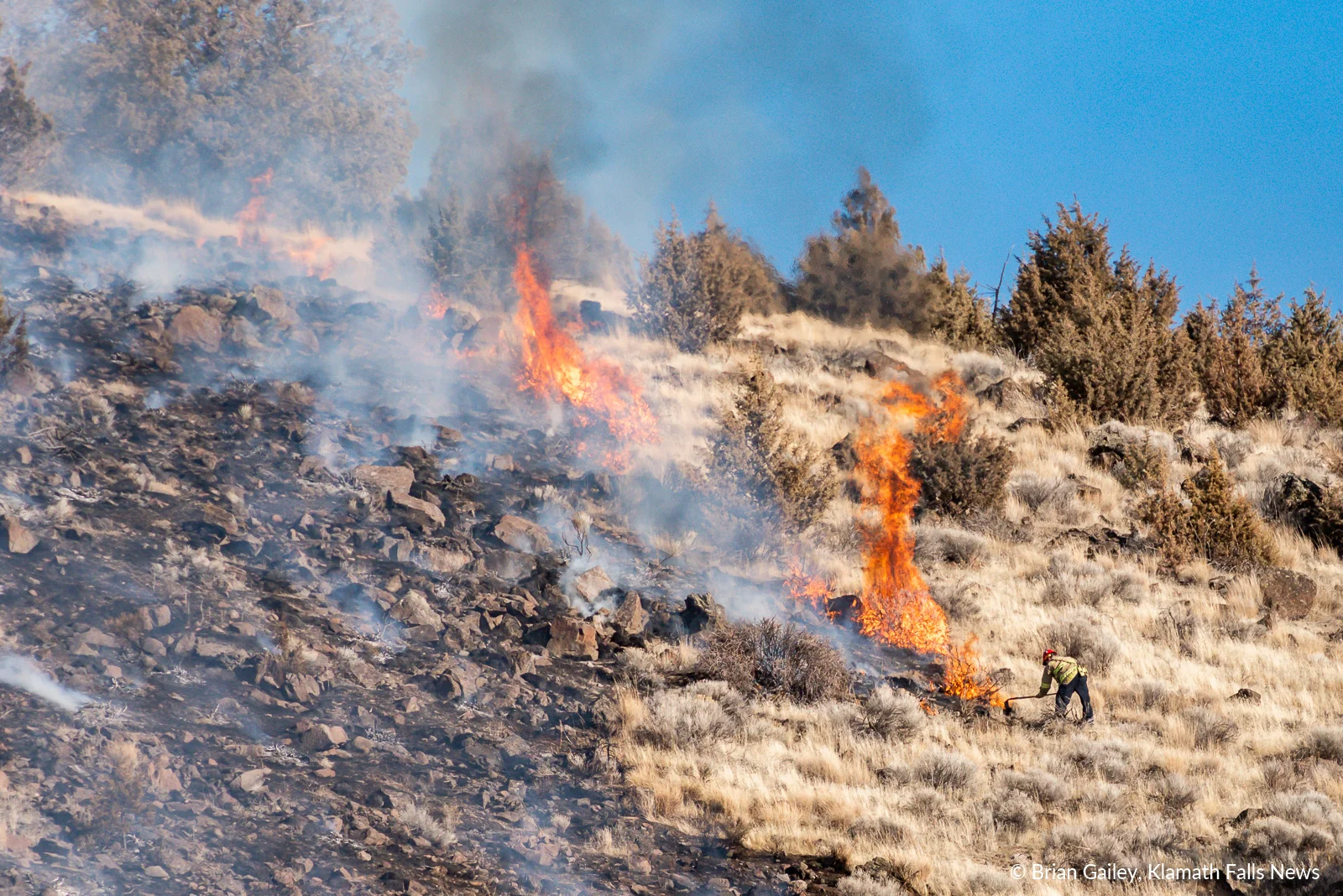 A firefighter battles flames on Stukel Mountain in Klamath Falls, Oregon. January 14, 2019 (Brian Gailey)