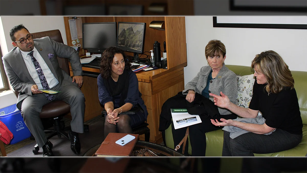 Klamath County School District board members Jill O’Donnell and Denise Kandra talk with state Rep. Diego Hernandez and a staff member during lobbying efforts Tuesday at the state Capitol in Salem.
