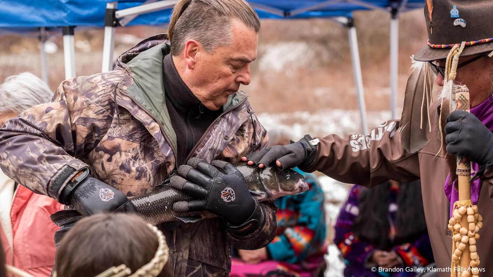 Klamath Tribal Elder, Rayson Tupper blesses a C’WAAM (Lost River Sucker) to be released during the annual spring C’WAAM Ceremony held by the Klamath Tribes. March 23, 2019 (Brandon Gailey / Klamath Falls News)