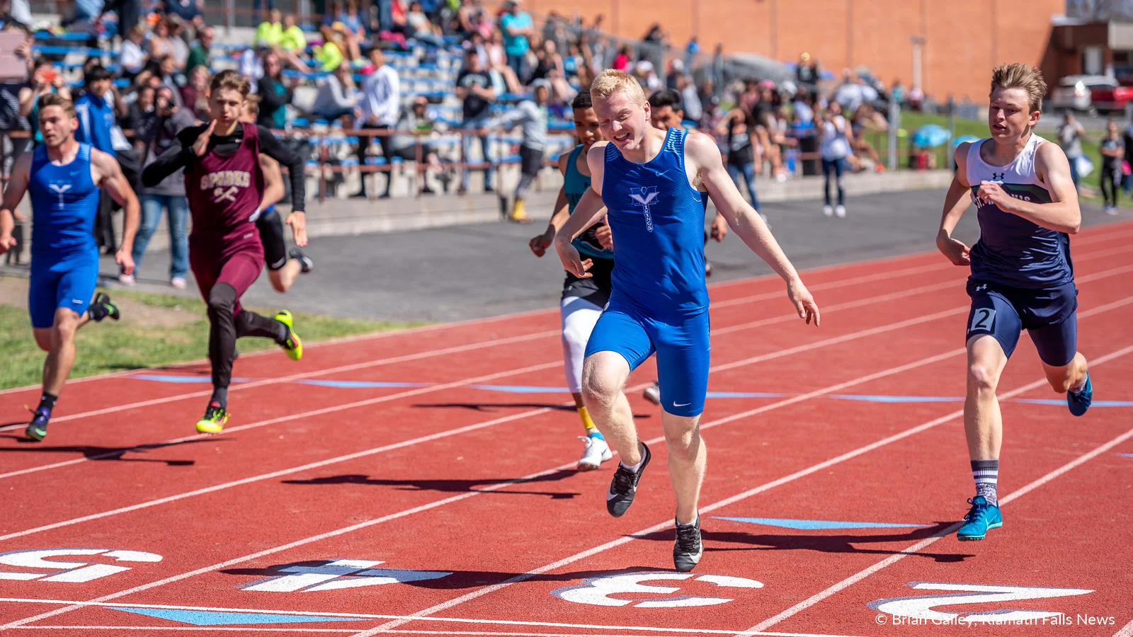 Mazama’s Ben Carringer steps across the finish line at 23.49 and into first place in the boys 200 meters during the 27th Annual Lithia Track and Field Invitational. April 27, 2019 (Image, Brian Gailey / Klamath Falls News)