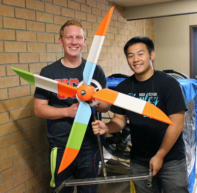Thys DeHoop and Dylan Huynh pose with their wind turbine. The blades, hub and gears were created in a CAD program and 3D printed. They will compete next week at the National KidWind Challenge in Houston. (Not pictured: Team members Jeffrey Hudson and Andrew Wilcher)